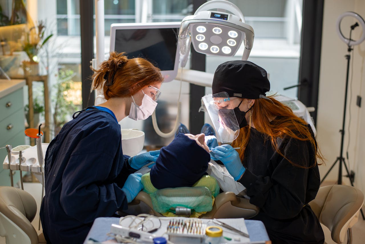 Two dentists performing a dental procedure with advanced equipment in a modern clinic.